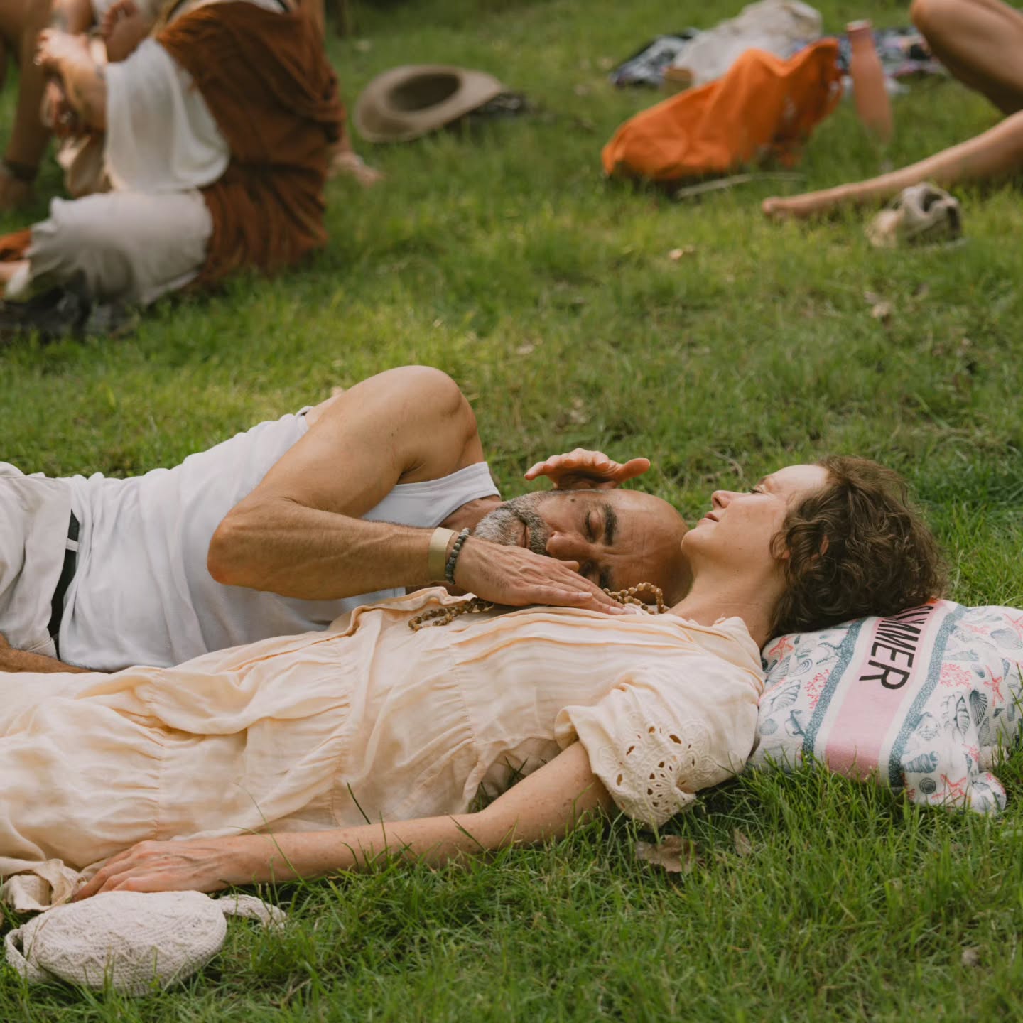 Couple resting on the grass at Shamballa
