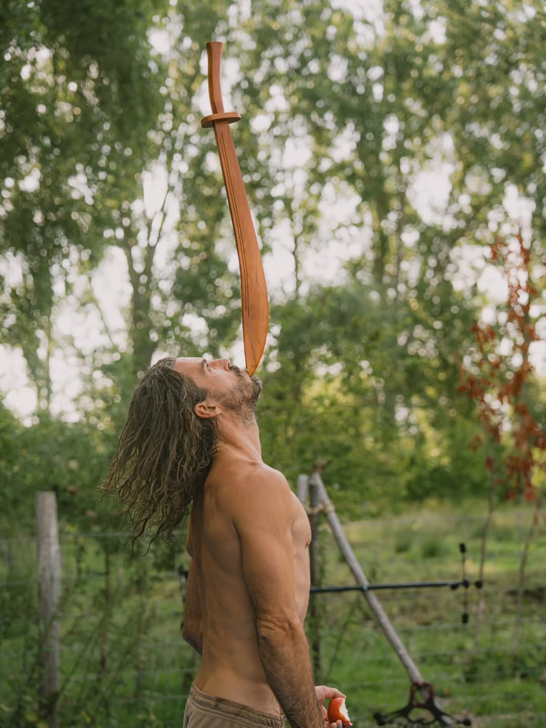 Performer balancing a wooden sword at Shamballa
